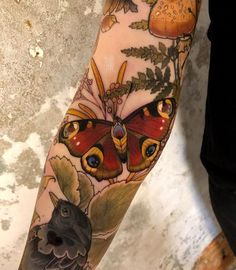 a person with a butterfly tattoo on their arm