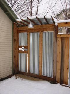 an outside view of a house with snow on the ground and sliding glass doors open