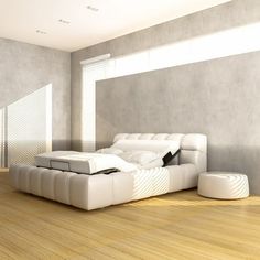 a large white bed sitting on top of a hard wood floor