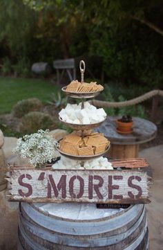 there is a sign that says s'mores on it next to some wine barrels