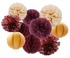 paper flowers and tissue pom poms are arranged in a cluster on a white background