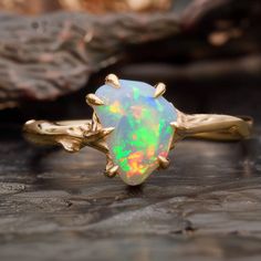 a white opal ring sitting on top of a wooden table