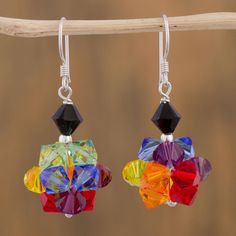 multicolored glass beaded earrings hanging from a branch