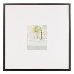 a white framed photograph with a tree in the background