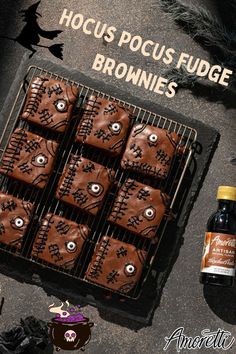 chocolate brownies on a cooling rack and bottle of booze next to it with the words hoccus pocus fudge browns