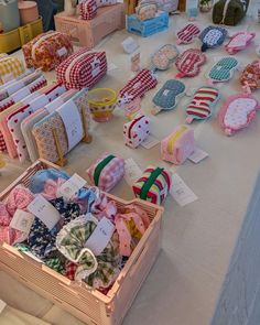 many different items are on the table with tags and ribbons in baskets next to each other