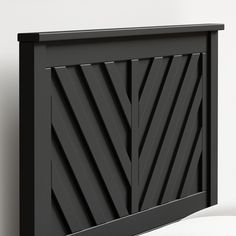 a close up of a black door on a white wall