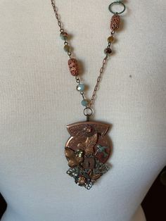 "Assemblage Jewelry This Neo-Victorian assemblage necklace is made mainly with wonderful vintage copper findings and the chain has a few sparkly beads for pizzaz. A truly lovely piece. Chain 12\" down each side pendant 3\"x1.5\" hangs a total 15\" Many of my necklaces have chains that can be adjusted for length. Just message me and ask. If it's possible, I'm happy to do so. Oh, please note that things really do look better in person, at least according to all the feedback I've had in the past!   PLEASE BE SURE TO READ ALL INFORMATION & POLICIES BELOW BEFORE ORDERING  I will combine shipping for the lowest cost. OOAK. Eclectic. Unique. Hand made jewelry & clothing made from vintage & new materials repurposed into Boho Chic, Victorian/Neo-Victorian, & Steampunk styles. Wearable Art for those Antique Gold Copper Necklace, Vintage Bronze Jewelry For Crafting, Antique Gold Beaded Vintage Necklace, Vintage Beaded Antique Gold Necklace, Victorian Metal Necklace With Vintage Charm, Vintage Metal Necklace With Patina, Antique Copper Medallion Necklace, Vintage Silver Copper Necklace, Vintage Copper Necklace In Silver