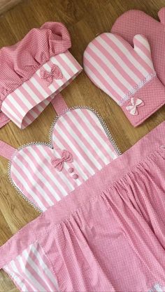 pink and white baby clothes laid out on the floor