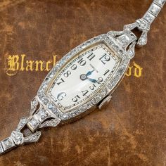 This exquisite circa 1930s Hamilton wristwatch (Style No. 989) features a diamond accented case and bracelet. The case is by the Wadsworth Watch Company (Case No. 0138038) and engraved details accent the side faces of the case and lugs. The case, lugs and bracelet are accented with a total of seventy- seven (77), bead set, round single cut diamonds. The case measures 16.5mm wide and 8.0mm thick. The silver colored dial features black Arabic numeral hour markers and blue steel hands. The movement Antique Costume Jewelry, Handsome Arab Men, Vintage Watches Women, Brand Presentation, Peridot Jewelry, Watches Luxury, Old Watches, Ladies Watches, Antique Watches