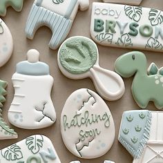 some decorated cookies are laying out on the table together with frosting and icing