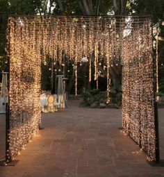 an outdoor area with lights strung from the ceiling