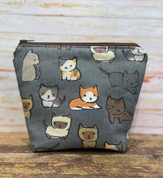 a small zipper bag with cats on it