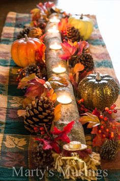 a table topped with lots of different types of candles and decorations on top of it