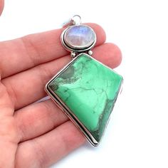 This large, kite shaped apple green variscite and rainbow moonstone pendant is set bezel set in sterling silver. Wear on a chain, leather or satin cord. If you  like large unique jewelry,  this is perfect for you! Metal Content: Sterling Silver -tested Measurements Length including bail:  3 1/8" (80mm) Width:  1 5/8" (41mm) Bail opening: 12mm x 6mm Weight: 25 Grams Stamps: none noted Condition: Excellent Pre-Owned Items will ship in a gift box or pouch Each piece is thoroughly examined and refin Chrysoprase Gemstone Pendant Jewelry, Unique Natural Stone May Birthstone Jewelry, Bohemian Sterling Silver May Birthstone Jewelry, Unique Jewelry With Natural May Birthstones, Bohemian Sterling Silver Jewelry For May Birthstone, Unique Natural Stones Jewelry For May Birthstone, Adjustable Silver Chrysoprase Jewelry, Chrysoprase Round Pendant Jewelry Gift, Adjustable Silver Jewelry With Chrysoprase