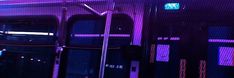 the inside of a subway car with purple lights on it's sides and doors