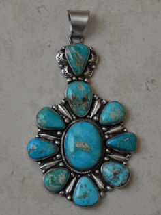 EXQUISITE, and AMAZING matted Sterling Silver Turquoise Cluster Pendant, handcrafted by Navajo artist SHELLA BICENTI. 4 1/2 inch high X 2 1/2 inch wide. Handmade Blue Turquoise Necklace Collectible, Handmade Blue Turquoise Collectible Necklace, Handmade Blue Turquoise Necklace For Collectors, Collectible Blue Turquoise Necklace With Large Pendant, Blue Turquoise Necklace With Large Pendant, Traditional Blue Turquoise Necklace With Patina, Artisan Blue Turquoise Necklace With Patina, Cluster Pendant, Silver Turquoise