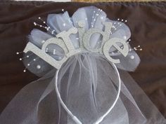 the bride's tiara is made out of tulle and sequins