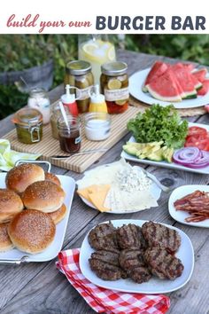 an outdoor picnic table with burgers, meat and vegetables