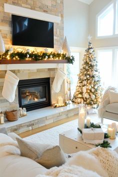 a living room decorated for christmas with candles and stockings on the fireplace mantels