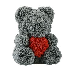 a teddy bear made out of roses with a crown on its head and holding a red heart