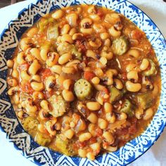 a bowl filled with beans and vegetables on top of a table