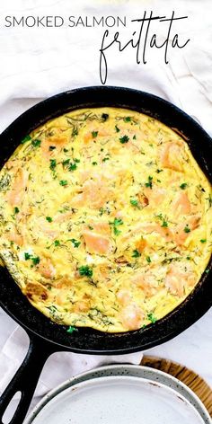 an omelet with shrimp and parsley in a cast iron skillet on a white table