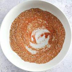 a white bowl filled with spices on top of a table