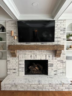 a fireplace with a flat screen tv mounted on it's wall above the fire place