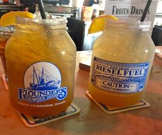 two mason jars filled with liquid sitting on top of a table