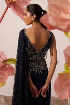 Navy blue draped gown with clematis moonlet bloom embroidery on the yoke using cutdana, sequin, crystals highlights, dangling cutdana strings and one sided mesh jaal drape embellished with crystals detailing. - Aza Fashions Pre-draped Evening Gown For Wedding, Draped Evening Dress With Sweep Train For Wedding, Wedding Evening Dress With Draped Sweep Train, Festive Evening Dress With Sweep Train For Gala, Festive Evening Gown With Sweep Train, Draped Evening Gown With Sweep Train, Festive Evening Dress With Sweep Train And Fitted Bodice, Gala Evening Dress With Fitted Bodice And Cape Sleeves, Traditional Drape Evening Dress For Gala