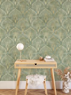 a desk with a lamp on it in front of a wallpapered background that looks like an art deco fan