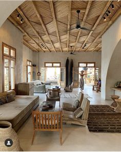 a living room filled with furniture and lots of windows