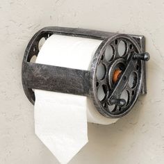 an old fashioned toilet paper dispenser on a wall