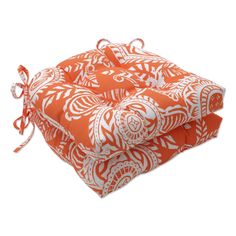 two orange and white cushions sitting on top of each other