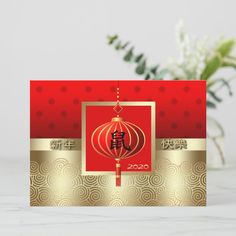 a red and gold chinese new year's card with an ornament on it