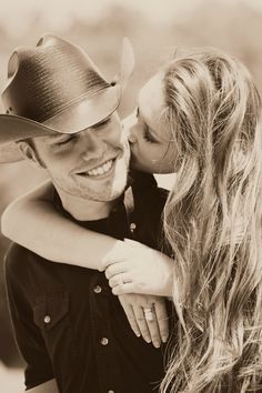 a man in a cowboy hat hugging a woman