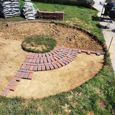 a brick pathway in the middle of a yard that is being constructed into a garden