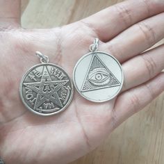 Pendant in 925 sterling silver. On one side, the Tetragrammaton is depicted, and on the other, the Eye of Providence, two of humanity's oldest amulets. Its diameter is 33 mm and its weight is approximately 10 gr. The pendant is made of solid silver and is accompanied by a black leather cord in three different lengths to be chosen by the client. Symbolic Medallion Jewelry For Commemoration, Symbolic Coin-shaped Sterling Silver Jewelry, Symbolic Silver Coin Necklace, Symbolic Sterling Silver Coin Jewelry, Silver Symbolic Coin Necklaces, Symbolic Star Of David Engraved Jewelry, Spiritual Sterling Silver Coin Jewelry, Silver Symbolic Engraved Jewelry, Symbolic Silver Engraved Jewelry