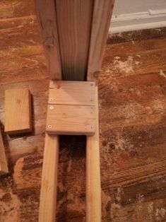 a wooden chair sitting on top of a hard wood floor next to a door way