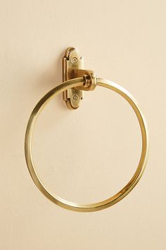 a gold towel ring hanging on the wall