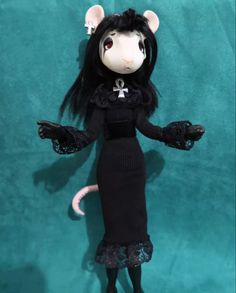 a doll is dressed in black and white