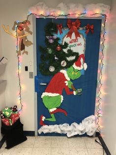 the grinch door is decorated with christmas lights and decorations, including a santa clause hat