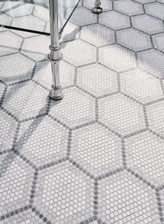 a glass table sitting on top of a tiled floor