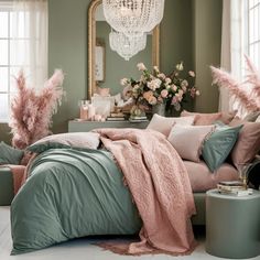 a bedroom with green walls, pink bedding and chandelier hanging from the ceiling