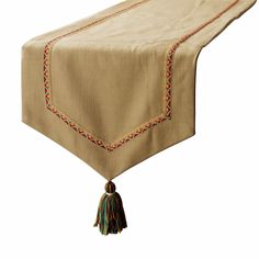 a table runner with tassels on it