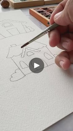 someone is drawing letters on paper with a pencil