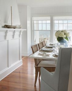 the dining room table is set with place settings for six people, along with an ocean view