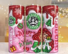 three starbucks coffee cans with christmas designs on them