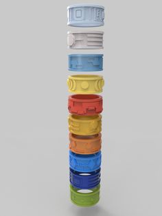 a stack of different colored plastic objects on a gray background